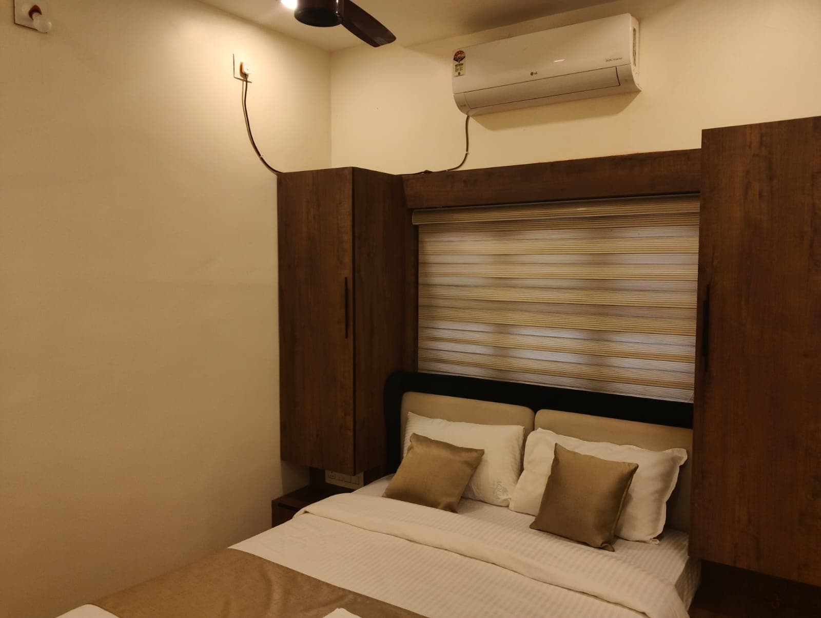 Lower Ground Bedroom Two with warm ambient lighting and wood wardrobes