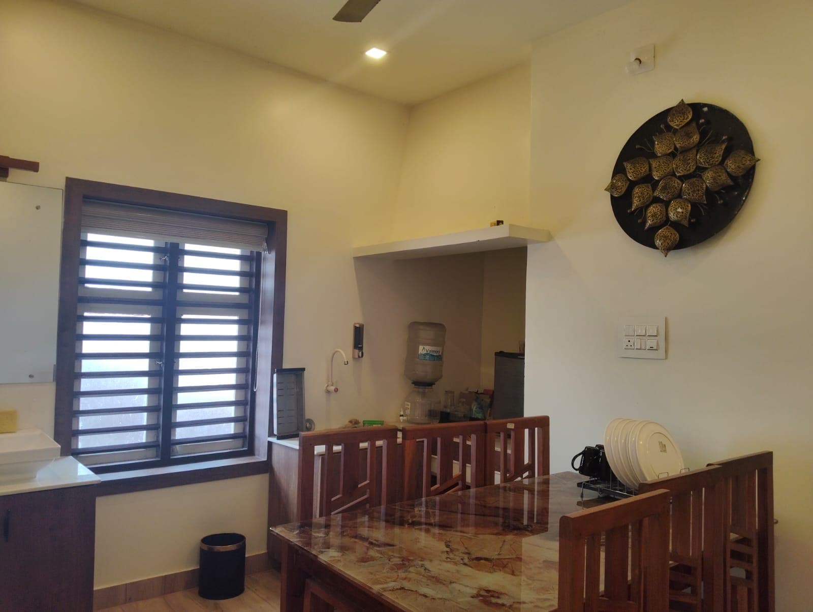 Lower Ground Dining Hall with marble table and kitchenette vanity