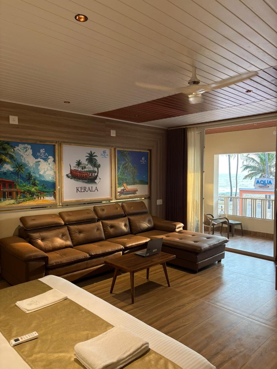 Upper Ground Grand Suite looking past leather lounge toward the private balcony and Arabian Sea